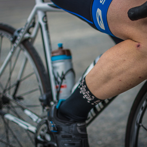 cycliste dans la Drôme derrière un champs de tournesol